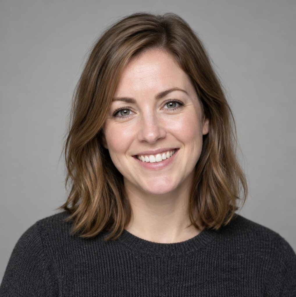 Portrait of a woman with light hair smiling at the camera