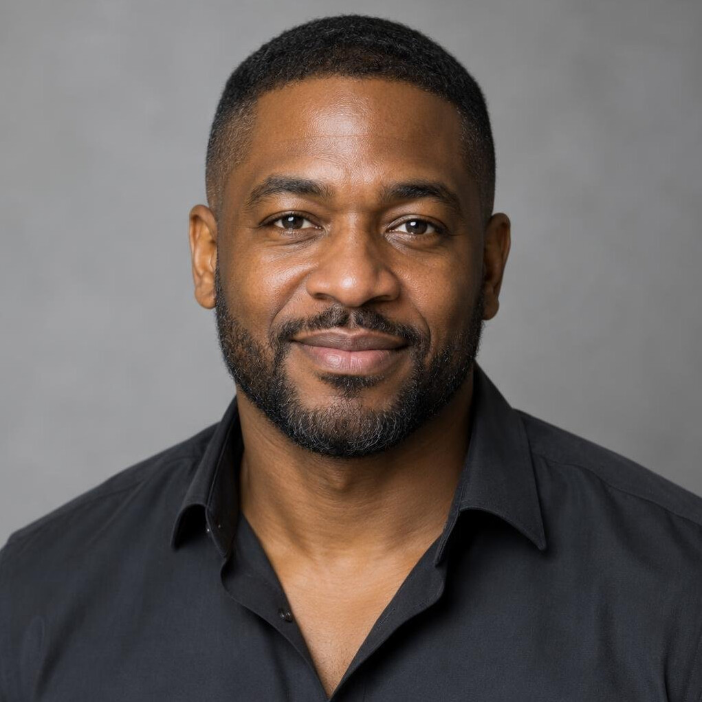 Portrait of a smiling man with short dark hair and a beard